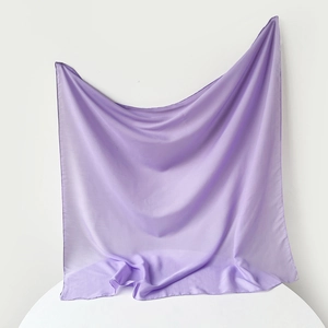 Detailed view of lightweight pale purple silk scarf with smooth translucent texture