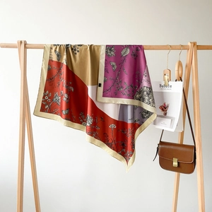 Elegant 90cm double-sided printed silk scarf with floral patterns on a wooden hanger