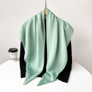 Detail shot of light mint green chiffon scarf with soft drape and airy texture