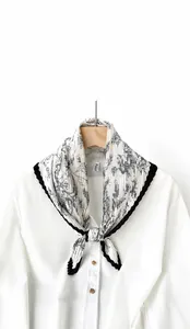 Detail of pleated rhombic silk scarf with floral print and black contrast borders