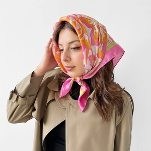 Floral satin square scarf tied as a French headscarf in vibrant pink and orange hues