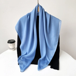 Detail of light blue sheer chiffon scarf showing soft semi-transparent texture and drape