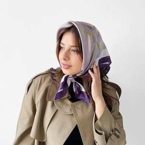 French style silk headscarf with purple floral print worn with a classic khaki trench coat