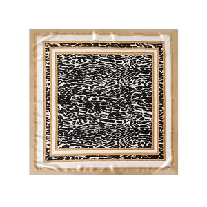 Macro shot of a satin square scarf featuring a classic leopard print and golden chain border