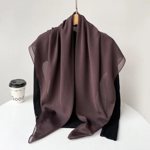 Detail of dark brown chiffon hijab showing soft semi-transparent fabric and smooth edges