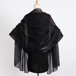 Detail showing semi-transparent black organza shawl material and fine stitching on the edge