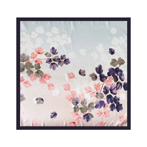 Detail showing elegant gradient silk scarf with purple and pink leaf prints and soft luster