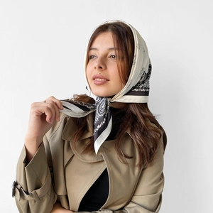 Detail of elegant black and white paisley silk scarf worn as a stylish headscarf