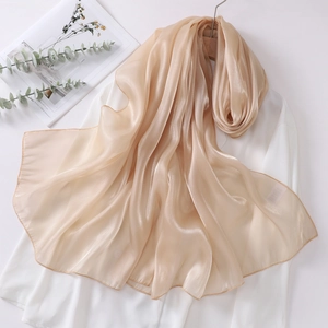 Detail of elegant champagne organza scarf with glossy finish and refined edges