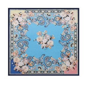 Detail showing the intricate floral and Paisley pattern on a light blue square silk scarf