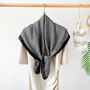 Detail of 90cm satin square scarf with black and white texture tied in a knot on clothing