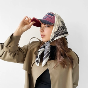 Detail of vintage burgundy baseball cap styled with a paisley print satin square scarf