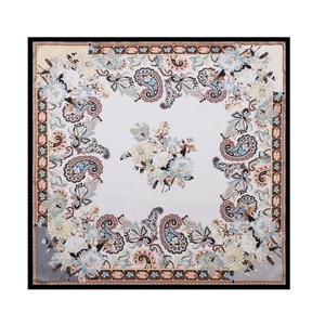 Close-up of vintage paisley and floral patterns on elegant satin silk square scarf
