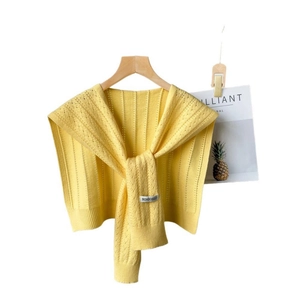 Bright yellow knitted shawl wrap with hollow wave pattern on wooden hanger