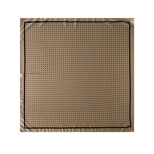 Detail of silk-like satin square scarf featuring golden-brown background and black polka dots