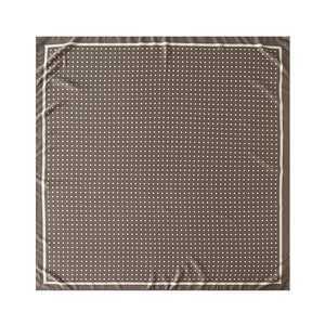 Macro shot of brown square scarf featuring elegant white polka dots and silk-like texture