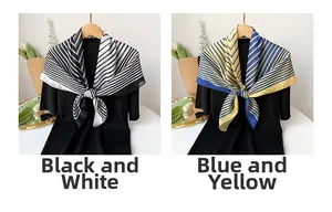 Detail of color-block striped silk scarves in black-white and blue-yellow on black knitwear