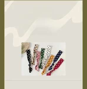 Detailed macro shot of various polka dot skinny scarves in premium chiffon fabric textures