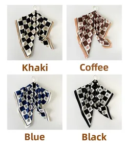 Dettaglio di quattro foulard in seta a scacchi nei colori kaki, caffè, blu e nero