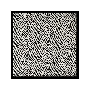 Detailed view of square silk scarf with black and white zebra pattern and satin texture