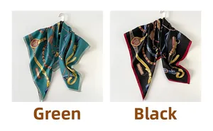 Detail of silk-like square scarf with horse bridle and golden chain print pattern