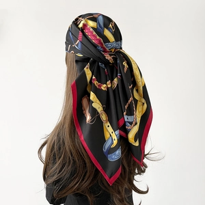 Retro equestrian style silk scarf with horse strap pattern tied on model's hair