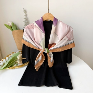 Elegant 90cm geometric silk scarf styled on a hanger with a modern colorful pattern