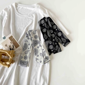 Detail of paisley pattern polka dot skinny scarves on a minimalist white t-shirt