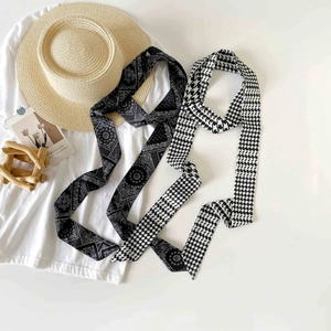 Detail of silk-like neck scarves with polka dots and bohemian patterns on summer props
