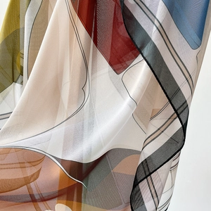 90cm square silk scarf with abstract geometric prints in vibrant red and blue colors