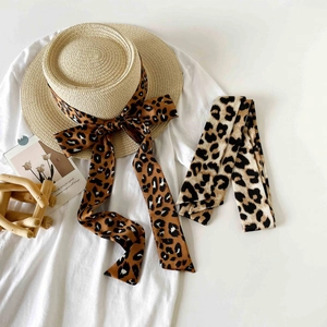 Summer straw hat set with leopard print silk scarf accessories on white backdrop