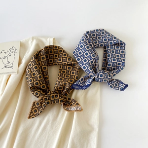 French retro cotton silk scarf with leopard print and lace edges on beige knitwear