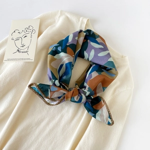 Detailed macro view of abstract print cotton scarf with vintage tones and lace trim edges
