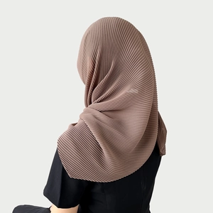 Detailed macro texture of mocha brown pleated chiffon hijab with high-density vertical folds