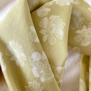 Detail of premium mustard green floral cotton scarf showing fine fabric texture
