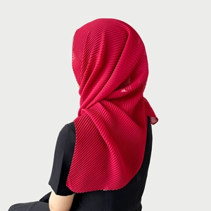 Detail showing the fine pleated texture and soft drape of the dark red chiffon hijab