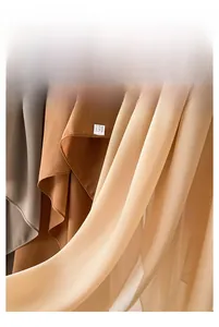 Detail of grey, caramel and champagne pearl chiffon fabric with light silky texture