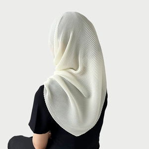 Detail of white pleated chiffon hijab showing the elegant drape and textured fabric finish