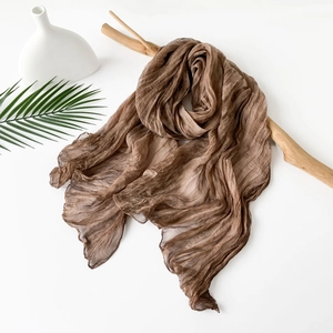 Detail view of coffee brown pleated scarf with fine ripple texture and hemmed edges