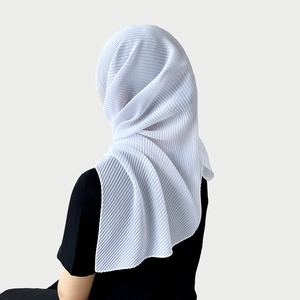 Detailed view of the pleated texture on a white chiffon hijab with lightweight draping