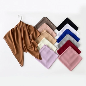 Flat lay display of twelve colorful pearl chiffon hijabs in various elegant solid tones