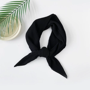 Detail of black plissé pleated chiffon scarf showing soft texture and fine fabric folds