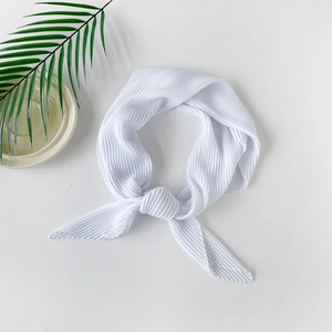 Detailed view of white pleated chiffon headscarf with refined textured fold craftsmanship
