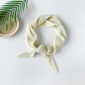 Macro shot of cream white pleated chiffon square scarf with delicate ribbed texture details