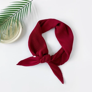 Macro detail of wine red pleated chiffon scarf with fine texture and draped fabric