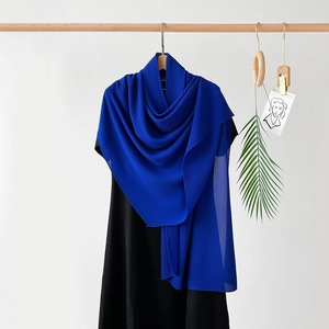 Detailed macro view of the royal blue pleated chiffon fabric texture and wavy edges