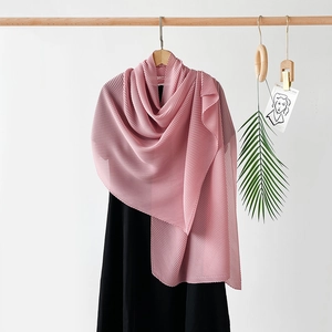 Detail of pink pleated chiffon scarf showing soft texture and elegant vertical folds