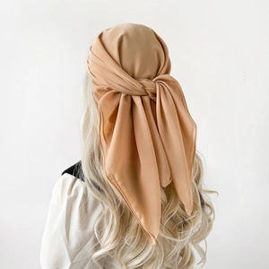 Rear view of an elegant camel chiffon headscarf tied in a classic back knot for women
