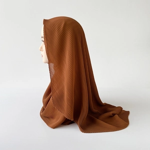 Detail of brown pleated chiffon hijab scarf featuring vertical crinkle texture on model