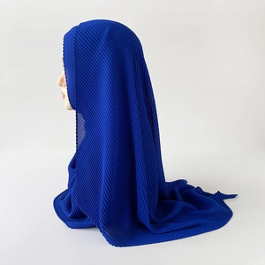 Detail of dark blue pleated chiffon hijab showing elegant texture and fabric drape